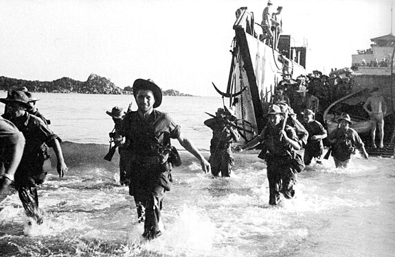 French Marines wading ashore off the coast of Annam (Central Vietnam) in July 1950, using US-supplied ships, weapons, equipment. Quote by Bernard Fall in gallery title.[14]:702