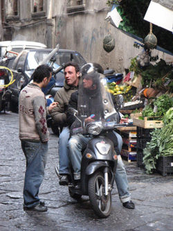 Humans instinctively communicate, as the conversation of these men in Naples, Italy, Italy shows.